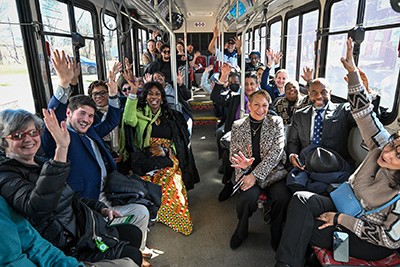 Group shot of folks riding a city bus