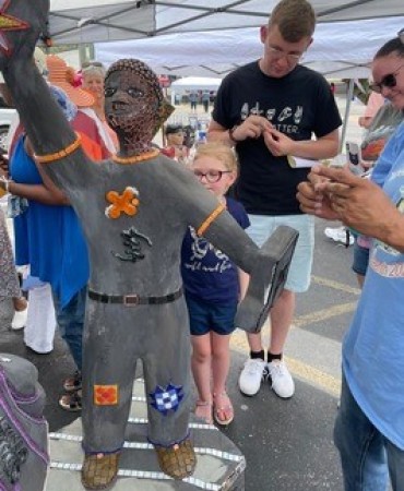 People working on the sculpture at the Black on Buchanan Juneteenth Block Party.