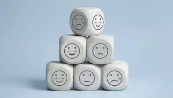 6 dice with a variety of faces drawn on them in a pyramid configuration