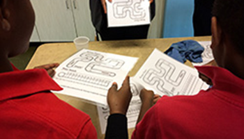 Students holding activity handouts