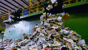 Huge pile of paper and plastic inside recycling facility