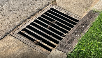 Stormwater grate between road and curb