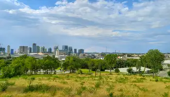 Nashville skyline from a distance with field and trees in foreground
