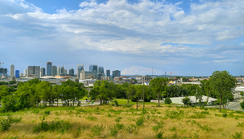 Nashville skyline from a distance with field and trees in foreground