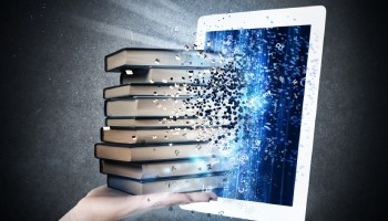 hand holding books coming out of a tablet