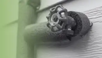 a water spigot attached to a house