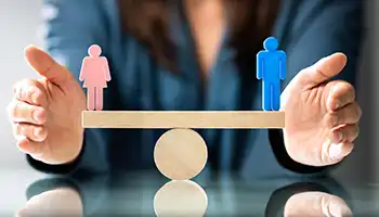 photo: person balancing male and female figures.