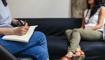 person with therapist in therapy session