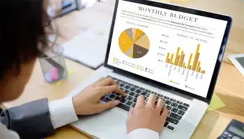 person using laptop computer with charts and graphs on screen