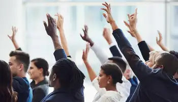 group of people with hands raised