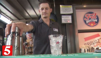 bartender serving at a bar