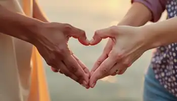 photo: two racially different people forming a heart with their hands