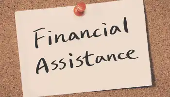 note pinned to a corkboard with the words Financial Assistance
