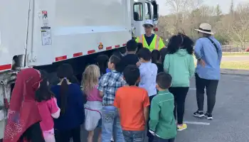 Waste Services employee talks with students about his job driving a recycling truck.