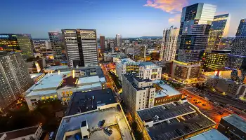 Nashville skyline at dusk with illuminated buildings and streets