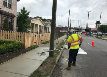 Metro Employee repairing a sidewalk.