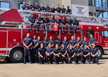 Fire Battalion 89 graduates in front of fire truck