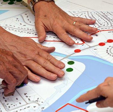 hands pointing at map