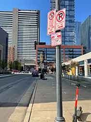 "No Parking" signs on pole next to downtown city street