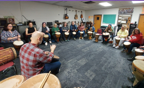 people playing the Djembe drum