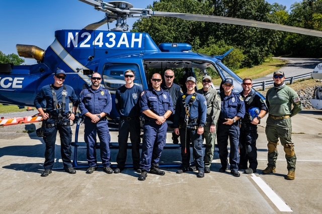 Urban Search and Rescue team standing in front of a helicopter