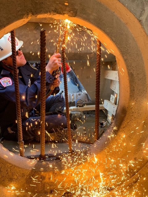 Urban Search and Rescue officer cutting a bar