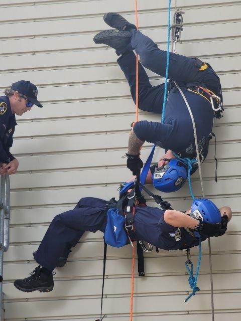 Urban Search and Rescue team practicing saving someone while suspended