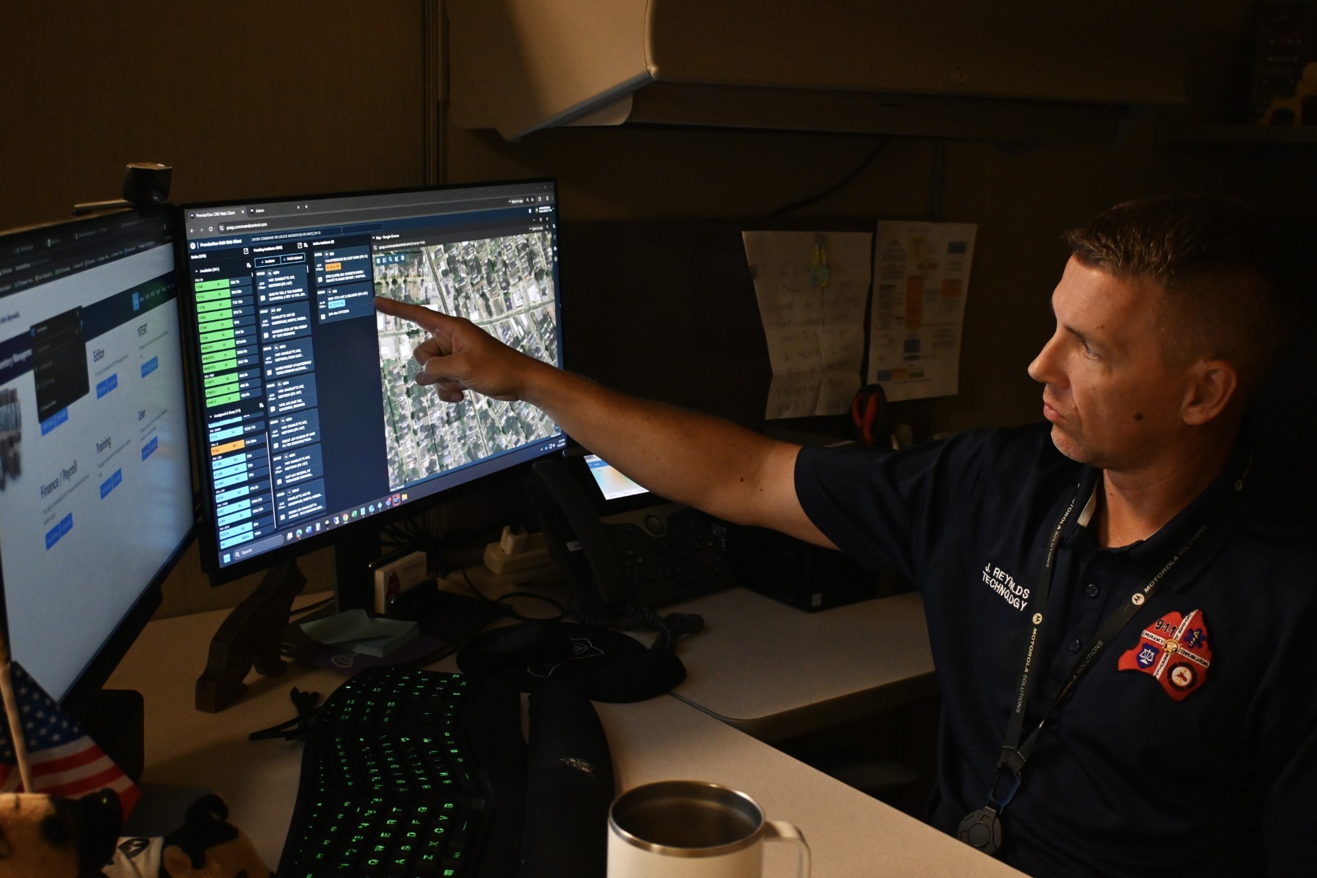 man points to computer monitor