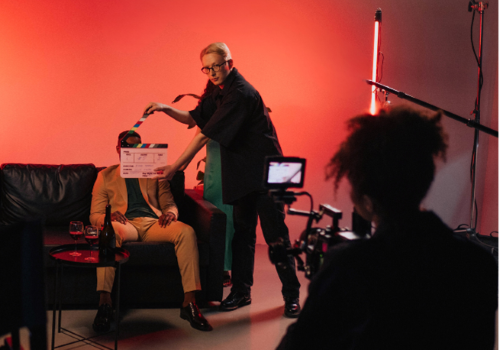 photo of man with a clapper board before the scene starts