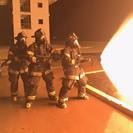 Photo of firefighter trainees using fire hose