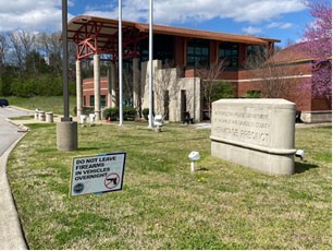 Photo of the outside of Hermitage Precinct with a sign reminding viewer to not leave firearms in a car.