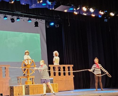 photo of looby stage with lights and young actors