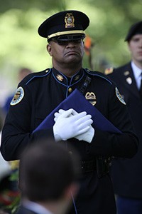 Metro Police Officer holding folded American flag
