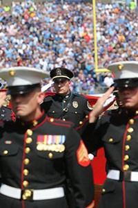 Metro Police and Military saluting at funeral for fallen comrade