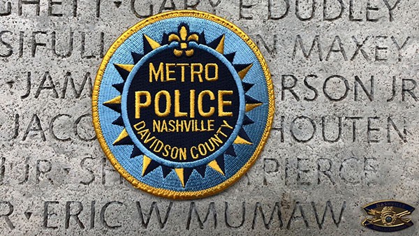 Metro Police patch superimposed over the Fallen Officers Wall