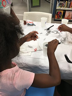 Photo of a child participating in a surface tension activity