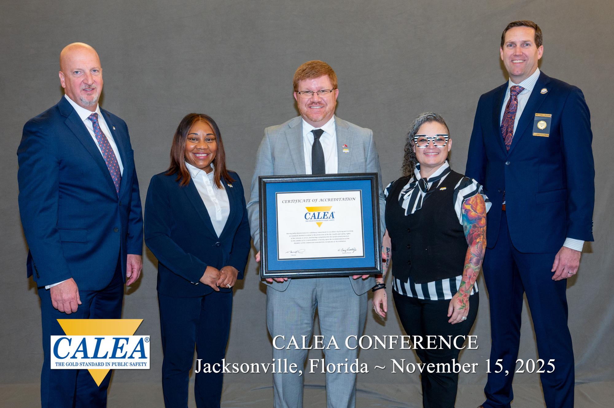 group stands with award