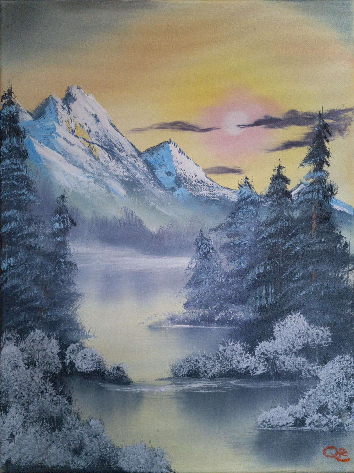 A tall snowy mountain towering over a calm frozen lake
