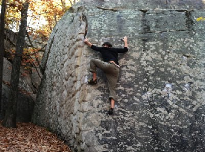 Guy in Black Shirt Rock Climbing