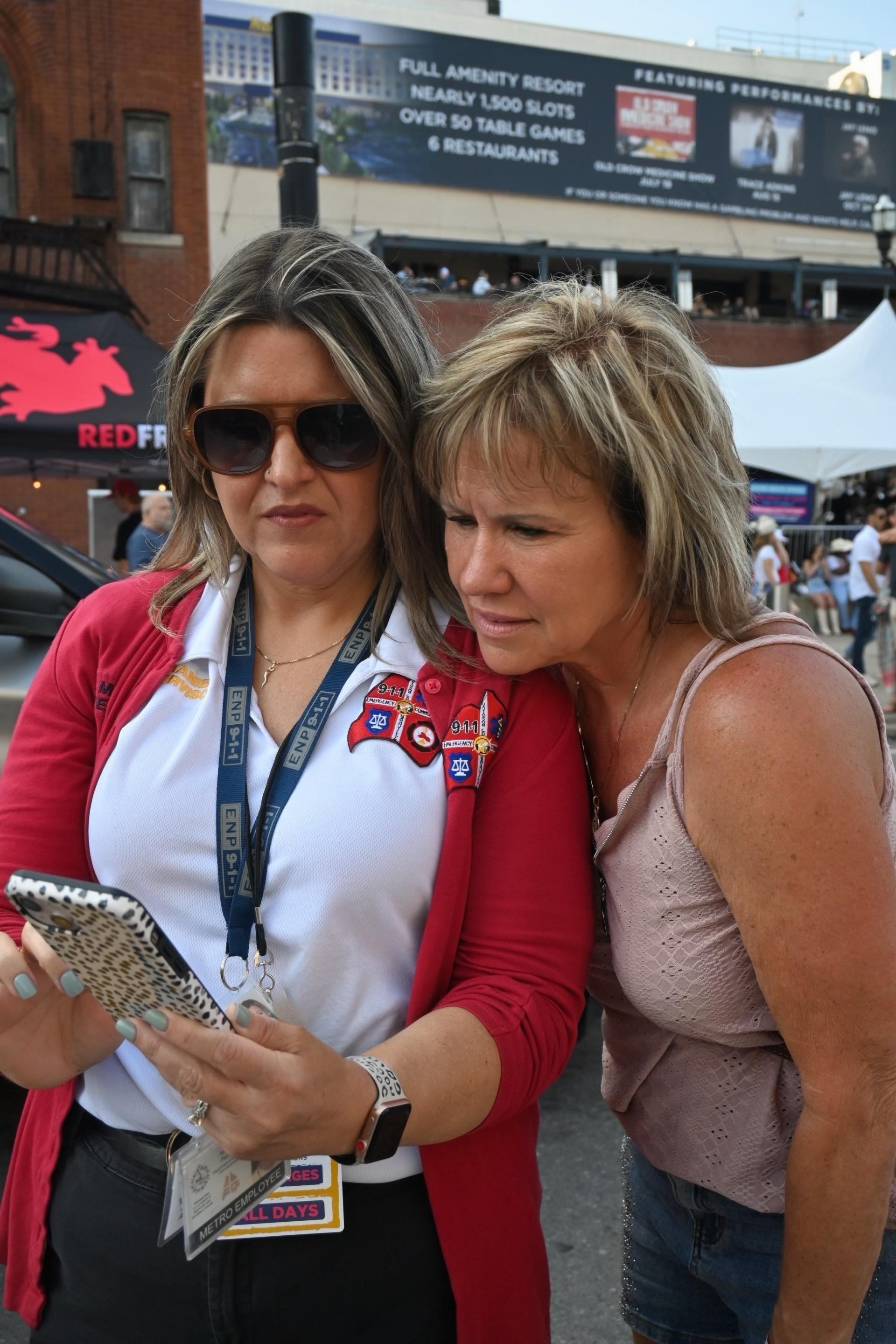 Women look at a cell phone