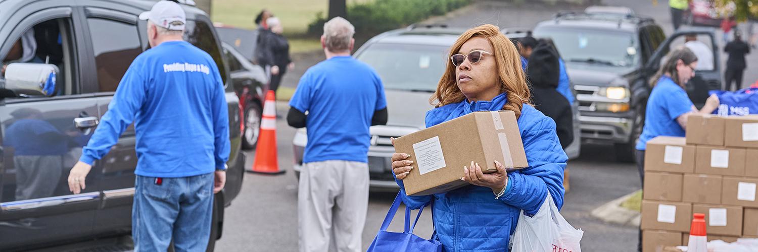 Photo of food being distributed to cars waiting in line