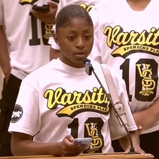 Young athlete in uniform giving a speech at an event