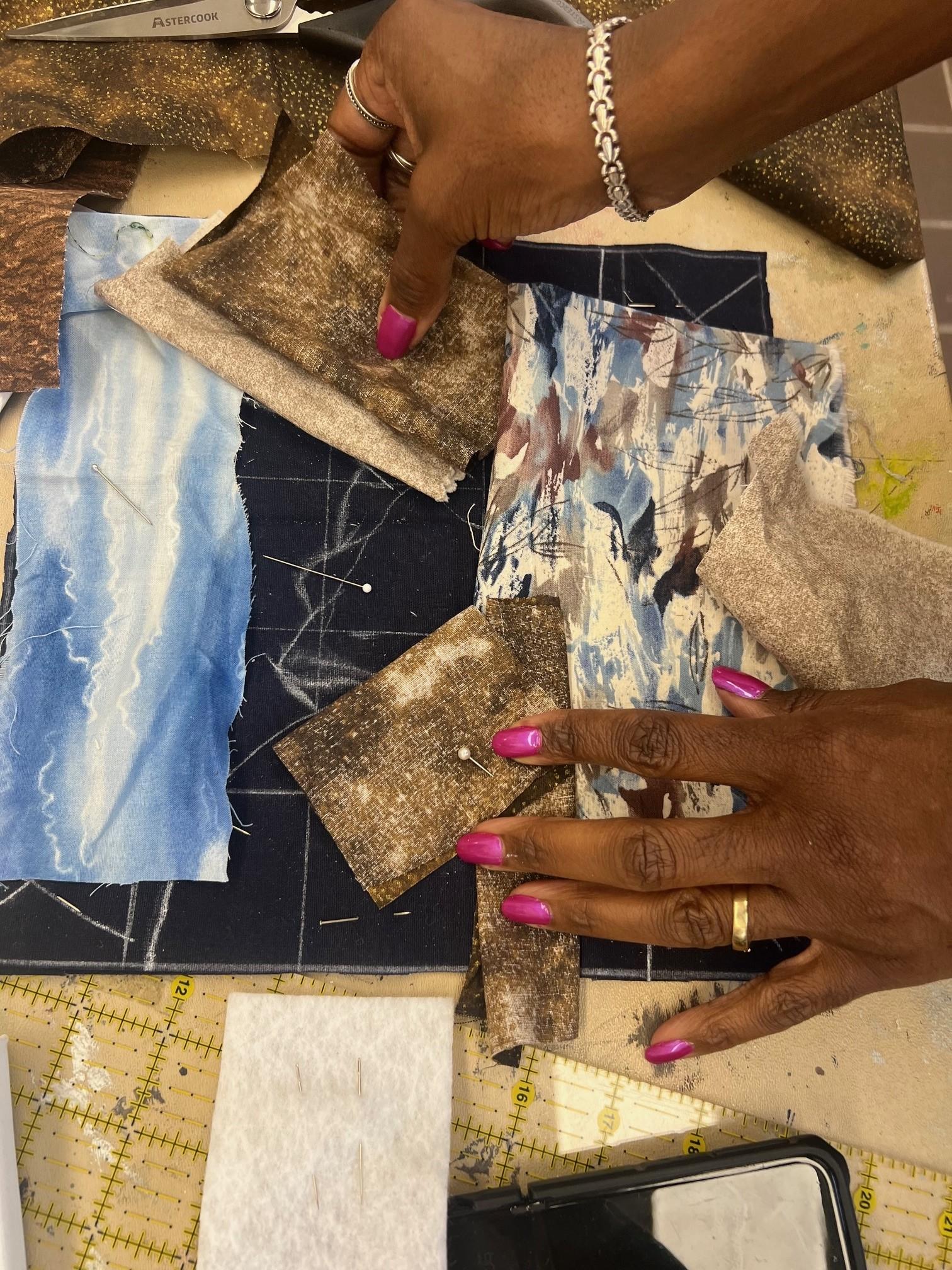 hands creating landscape with fabric on a table