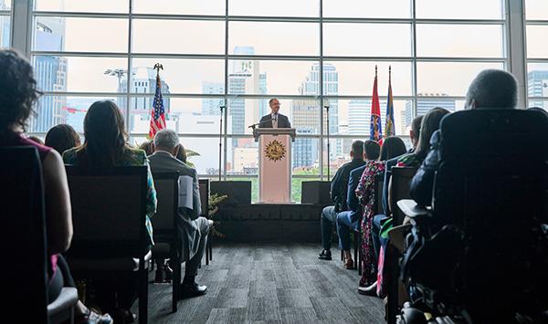 Mayor Freddie O'Connell delivers State of Metro address to seated audience in modern conference room with large windows