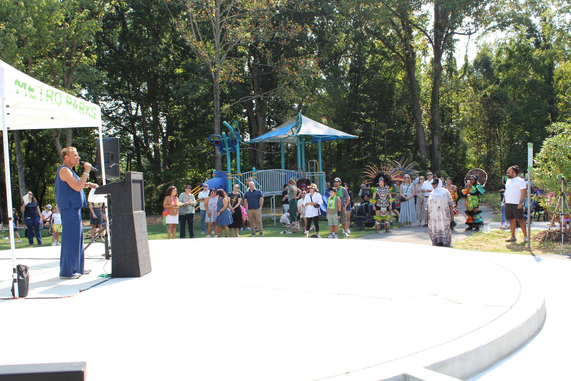 councilwoman speaking under tent at podium