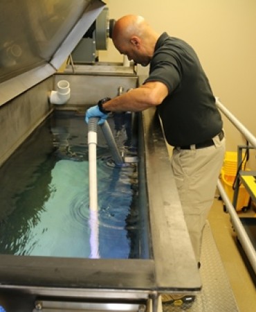 Retrieving a bullet from the water tank.