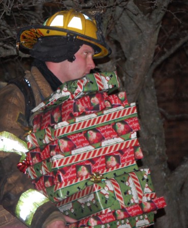 firefighter carrying gifts