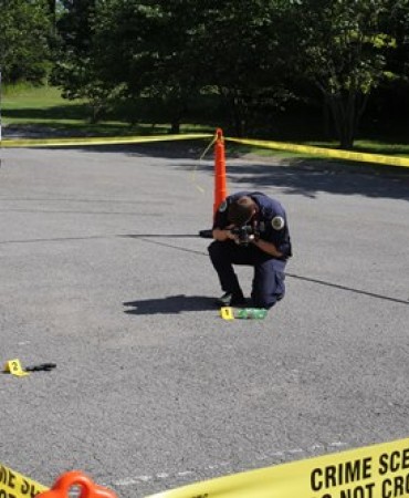 Crime Scene Officer photographs a crime scene.