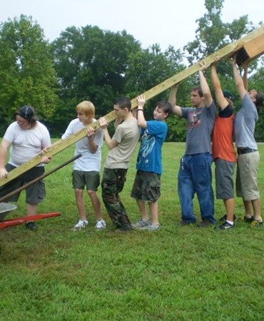 volunteers putting up birdhouse