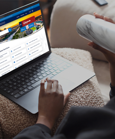 Person browsing Nashville.gov website on laptop